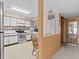 Galley-style kitchen with white cabinets and tiled backsplash at 5537 Sea Forest Dr # 307, New Port Richey, FL 34652