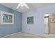 Bright bedroom with neutral walls and carpet, featuring two framed pictures and access to laundry at 5537 Sea Forest Dr # 307, New Port Richey, FL 34652