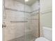 Large walk-in shower with grab bars and neutral tile at 5537 Sea Forest Dr # 307, New Port Richey, FL 34652