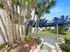 Condo entrance with lush landscaping and a covered walkway at 5537 Sea Forest Dr # 307, New Port Richey, FL 34652