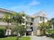 Condo building exterior showcasing landscaping and parking at 5537 Sea Forest Dr # 307, New Port Richey, FL 34652