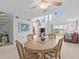 Bright dining room with wood table and chairs near spiral staircase at 5537 Sea Forest Dr # 307, New Port Richey, FL 34652