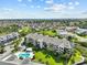 Aerial view of condo building with pool and surrounding neighborhood at 5537 Sea Forest Dr # 307, New Port Richey, FL 34652