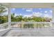 White-railed balcony overlooking a lush green landscape with houses in the distance at 329 Sunset Way, Palm Harbor, FL 34683