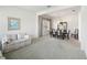 Open living and dining area with carpet and large windows at 329 Sunset Way, Palm Harbor, FL 34683
