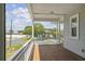 Covered porch with white railings and street view at 329 Sunset Way, Palm Harbor, FL 34683