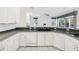 Modern kitchen with white cabinets, granite countertops, and a breakfast bar at 329 Sunset Way, Palm Harbor, FL 34683