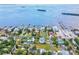 Aerial view of waterfront home with private dock and tennis court at 329 Sunset Way, Palm Harbor, FL 34683