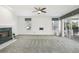 Bright living room featuring a fireplace and sliding glass doors leading to a deck at 329 Sunset Way, Palm Harbor, FL 34683