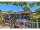 Ozona Pizza exterior with outdoor seating and white picket fence at 329 Sunset Way, Palm Harbor, FL 34683