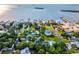 Aerial view of waterfront home with private dock and tennis court at 329 Sunset Way, Palm Harbor, FL 34683