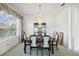 Formal dining room with a chandelier and large windows at 329 Sunset Way, Palm Harbor, FL 34683