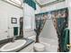 Clean bathroom with a shower/tub combo and green accents at 329 Sunset Way, Palm Harbor, FL 34683