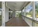 Spacious screened porch with wood flooring and scenic views at 329 Sunset Way, Palm Harbor, FL 34683