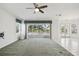 Spacious living room with balcony access and stunning water views at 329 Sunset Way, Palm Harbor, FL 34683