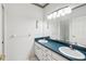 Bathroom with double vanity and teal countertop at 329 Sunset Way, Palm Harbor, FL 34683