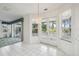 Dining area with tile floors, sliders to balcony, and chandelier at 329 Sunset Way, Palm Harbor, FL 34683