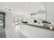 Eat-in kitchen with white cabinets, granite countertops, and access to a back porch at 329 Sunset Way, Palm Harbor, FL 34683