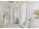 Bright entryway with tile flooring, access to kitchen and patio at 329 Sunset Way, Palm Harbor, FL 34683