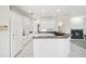 Modern kitchen with white cabinets, granite countertops, and a breakfast bar at 329 Sunset Way, Palm Harbor, FL 34683