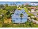 Aerial view of home's rear, showcasing a large yard and waterfront access at 329 Sunset Way, Palm Harbor, FL 34683