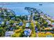 Aerial view of waterfront community with tennis courts and lush landscaping at 329 Sunset Way, Palm Harbor, FL 34683