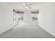 Bright bedroom with carpet flooring, two windows, and a door to balcony at 329 Sunset Way, Palm Harbor, FL 34683