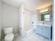 Bathroom with white subway tile and blue vanity at 1513 55Th N Ave, St Petersburg, FL 33703