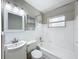 Bathroom with white fixtures, tub, and single sink at 1513 55Th N Ave, St Petersburg, FL 33703