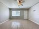 Vacant living room features tile floors, ceiling fan and bright lighting at 1513 55Th N Ave, St Petersburg, FL 33703