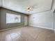 This vacant living room offers a ceiling fan and tile floors at 1513 55Th N Ave, St Petersburg, FL 33703