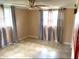 Empty bedroom featuring tile flooring, natural light, and neutral wall color at 5144 Chime Way, Holiday, FL 34690