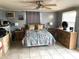 Cozy bedroom featuring a ceiling fan, tile floors, and neutral wall color at 5144 Chime Way, Holiday, FL 34690