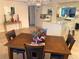 Dining area with wooden table and chairs, chandelier, and tiled flooring, perfect for Gathering meals and gatherings at 5144 Chime Way, Holiday, FL 34690