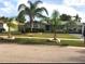 Ranch-style home with palm trees and well-maintained landscaping at 5144 Chime Way, Holiday, FL 34690