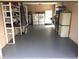 Spacious garage equipped with laundry machines and ample storage shelving, maximizing functionality and organization at 5144 Chime Way, Holiday, FL 34690