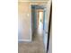 Hallway with tile floors leading to other rooms, white trim, and neutral paint, creating a cohesive flow at 5144 Chime Way, Holiday, FL 34690