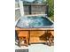 Hot tub featuring a wood surround and steps, creating a relaxing outdoor oasis at 5144 Chime Way, Holiday, FL 34690