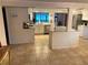 Bright kitchen with white cabinets, an island, and stainless steel appliances at 5144 Chime Way, Holiday, FL 34690