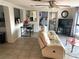 Open-concept living room with tile floors, and natural light; the Primary bedroom is visible at 5144 Chime Way, Holiday, FL 34690