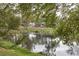 Peaceful lake view with lush vegetation and calm waters at 5242 Bougenville Dr, New Port Richey, FL 34652