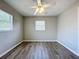 Spacious bedroom with wood-look floors and a ceiling fan at 1513 55Th N Ave, St Petersburg, FL 33703