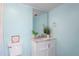 Light blue bathroom with a white vanity and marble countertop at 2511 Dolly Bay Dr # 308, Palm Harbor, FL 34684