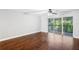 Hardwood floor bedroom with sliding glass doors to balcony at 2511 Dolly Bay Dr # 308, Palm Harbor, FL 34684