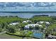 Aerial view showcasing community, lake access, and tennis courts at 2511 Dolly Bay Dr # 308, Palm Harbor, FL 34684