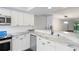 Modern kitchen with white cabinets, stainless steel appliances, and marble countertops at 2511 Dolly Bay Dr # 308, Palm Harbor, FL 34684