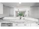Modern kitchen with white cabinets and marble countertops at 2511 Dolly Bay Dr # 308, Palm Harbor, FL 34684