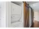 Stackable washer and dryer in a closet with barn doors at 2511 Dolly Bay Dr # 308, Palm Harbor, FL 34684