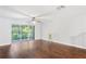 Spacious living room featuring hardwood floors and sliding glass doors to balcony at 2511 Dolly Bay Dr # 308, Palm Harbor, FL 34684