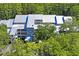 Aerial view of a waterfront community with lush landscaping and tennis courts at 2511 Dolly Bay Dr # 308, Palm Harbor, FL 34684